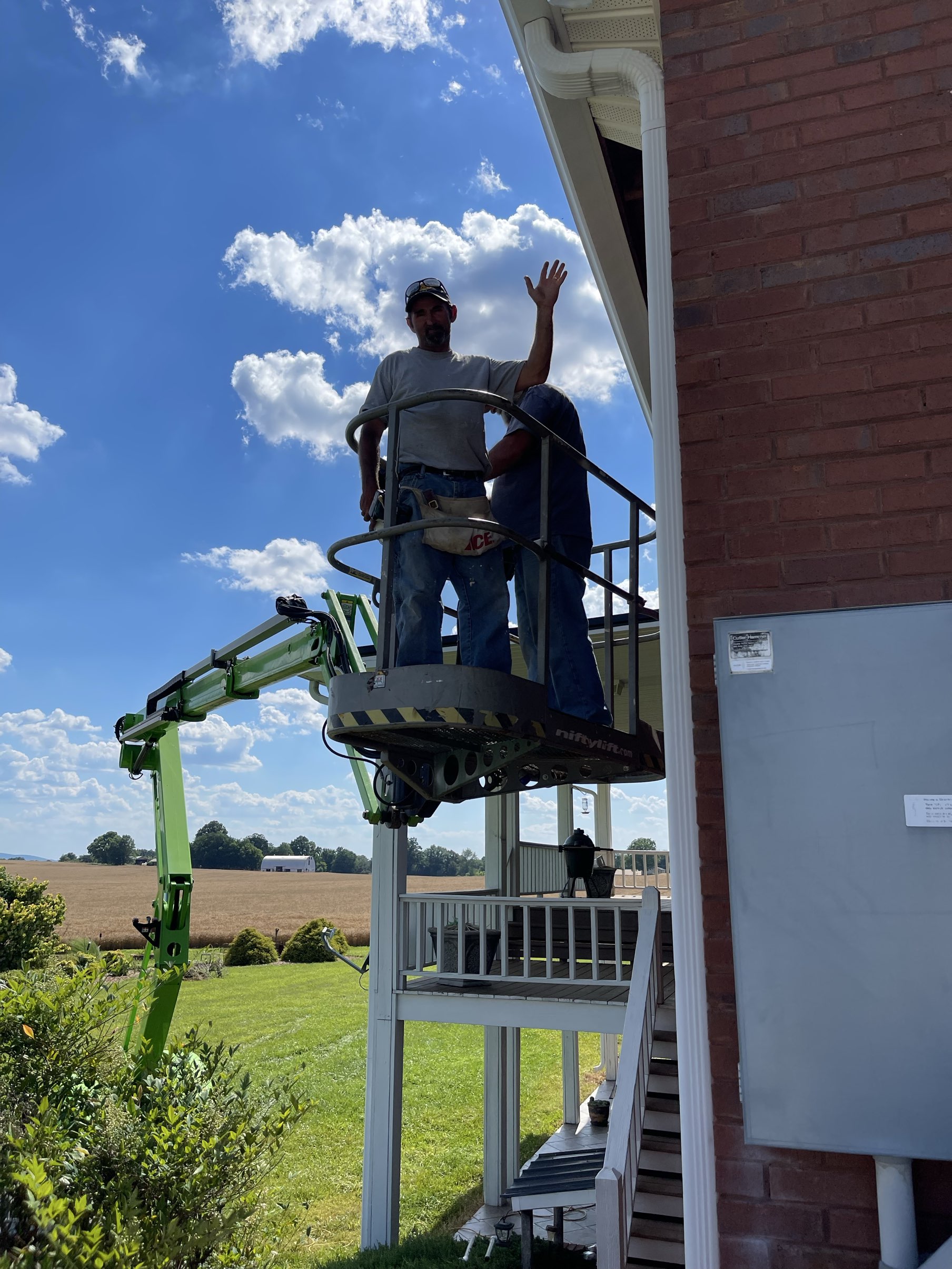 Workers on lift performing exterior repairs